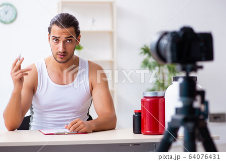 Young male blogger in dieting concept Young male blogger in dieting concept 64076431