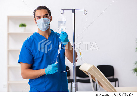 Young male doctor working in the clinic 64078037