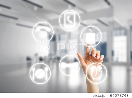 Modern office interior and close of businesswoman hand choosing symbol on application interface 64078743