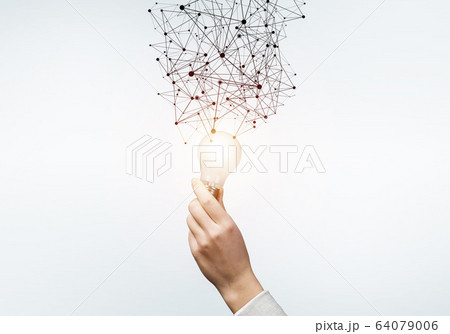Human hand with glowing lamp and abstract network 64079006