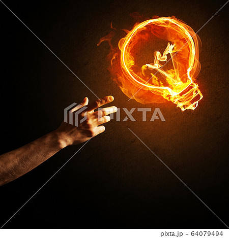 Concept of electricity or inspiration with burning light bulb and creation gesture 64079494