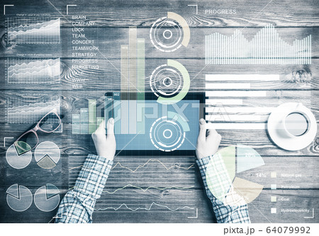Business workplace with tablet device coffee cup and media graph Business workplace with tablet device coffee cup and media graph 64079992