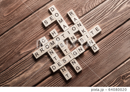 Conceptual business keywords on table with elements of game making crossword Conceptual business keywords on table with elements of game making crossword 64080020
