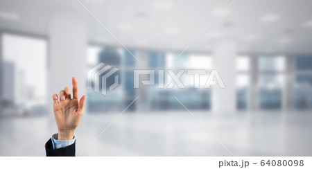 Choosing gesture of businessperson in elegant modern interior in sunshine light Choosing gesture of businessperson in elegant modern interior in sunshine light 64080098