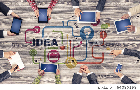 Top view of businesspeople sitting at table and using gadgets 64080198