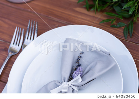 Beautifully decorated wooden table in a summer Beautifully decorated wooden table in a summer 64080450