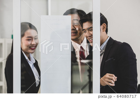 Businesspeople surrounded the placard board. Businesspeople surrounded the placard board. 64080717