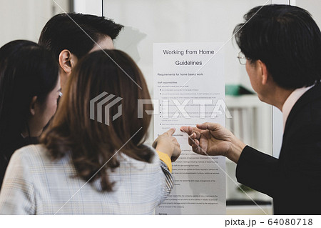 Businesspeople surrounded the placard board. Businesspeople surrounded the placard board. 64080718