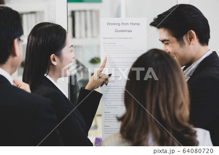 Businesspeople surrounded the placard board. Businesspeople surrounded the placard board. 64080720