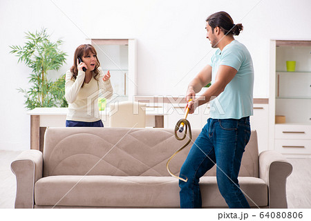 Young couple and snake in the flat Young couple and snake in the flat 64080806