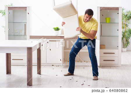 Young man and a lot of cockroaches at home 64080862