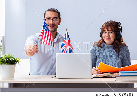 Young female student and male english teacher in the classroom Young female student and male english teacher in the classroom 64080882