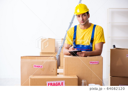 Young male professional mover doing home relocation Young male professional mover doing home relocation 64082120