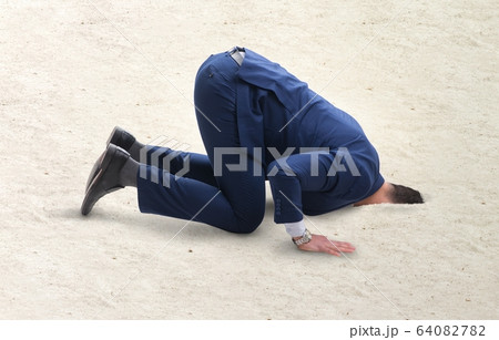 Businessman hiding his head in sand escaping from problems 64082782