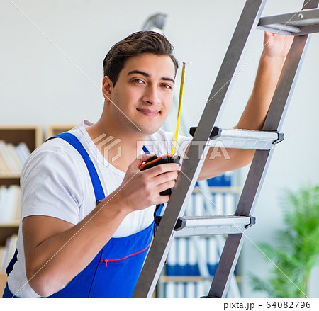 Repairman working with measurement tape Repairman working with measurement tape 64082796