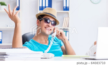 Businessman preparing for vacation in the office Businessman preparing for vacation in the office 64083710