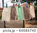 Dry mask Many masks for protection against Covid-19 were washed and hung for drying. To reuse it again because the mask was in short supply or expensive during the crisis. Selective focus 64084740