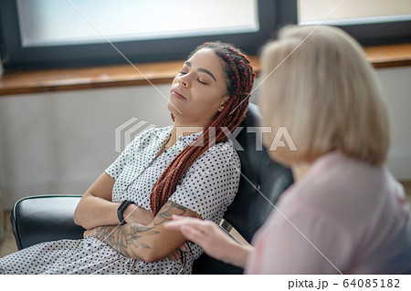 Young woman having a therapy session and feeling frustrated 64085182
