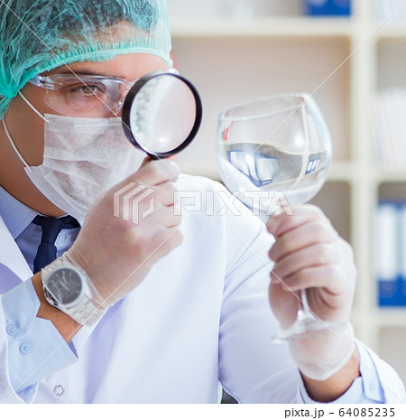 Forensics investigator working in lab on crime evidence Forensics investigator working in lab on crime evidence 64085235