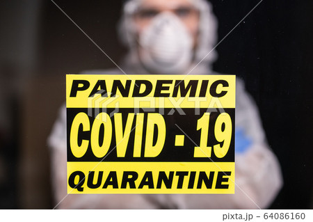 Man in protective white overalls, mask and glasses on his face. Coronavirus, pandemic, covid-19, flu and quarantine concept. 64086160