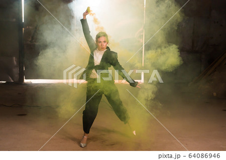 Pasadoble, latin solo dance and contemporary dance - Young beautiful female dancing into smoke cloud Pasadoble, latin solo dance and contemporary dance - Young beautiful female dancing into smoke cloud 64086946