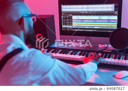 Professional musician recording synthesizer in digital studio at home, Music production technology concept. Professional musician recording synthesizer in digital studio at home, Music production technology concept. 64087027