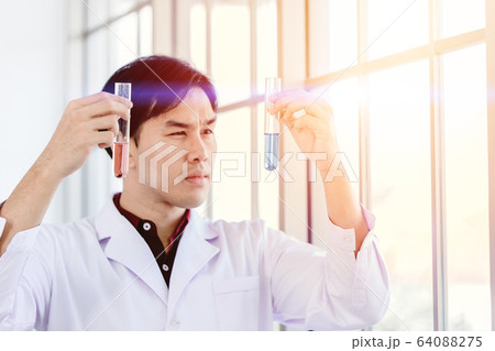 Scientist happy to successful discover new drug formula by choice select good chemical liquid 64088275