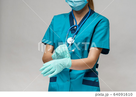 medical doctor nurse woman with stethoscope wearing protective mask and rubber or latex gloves medical doctor nurse woman with stethoscope wearing protective mask and rubber or latex gloves 64091610