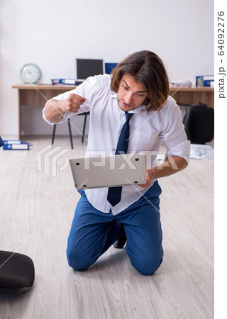 Young male employee unhappy with his work 64092276