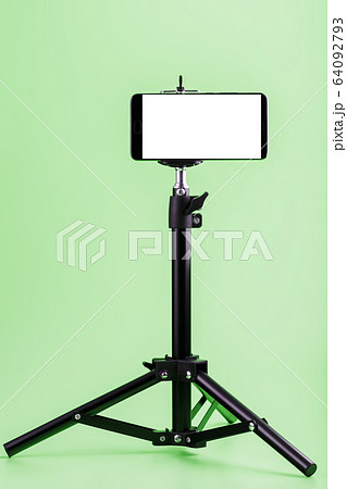 Mobile phone on a tripod with a clear white Mobile phone on a tripod with a clear white 64092793