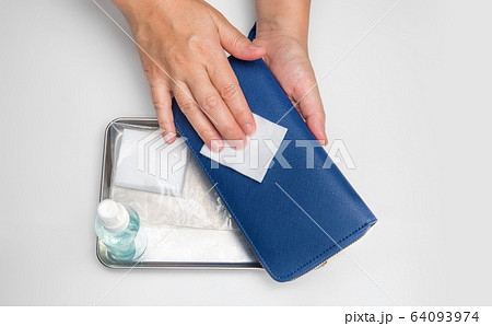 Cleaning wallet with alcohol to protection from covid-19 64093974