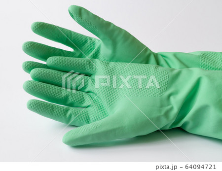 Hand in green latex dishwashing gloves on a white background Hand in green latex dishwashing gloves on a white background 64094721