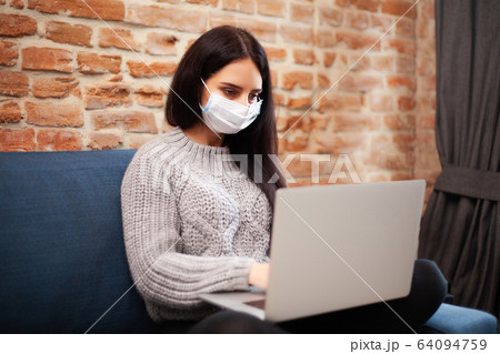 Woman stay at home during an epidemic and working on a laptop Woman stay at home during an epidemic and working on a laptop 64094759