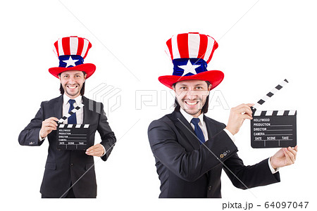Man with USA hat and movie board isolated on white 64097047