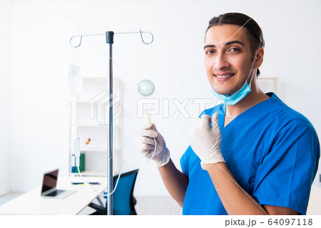 Young male doctor working in the clinic 64097118