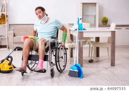 Young man in wheel-chair cleaning the house Young man in wheel-chair cleaning the house 64097535