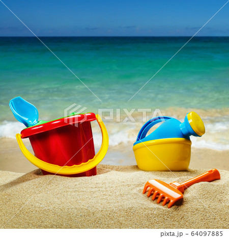 children's toys on the sea sand on the background 64097885