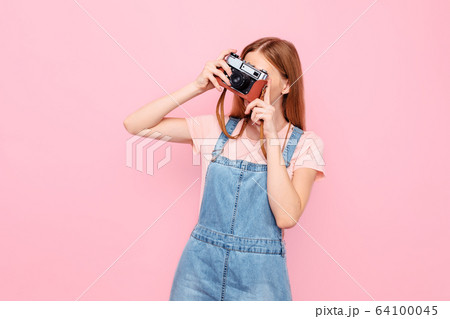 stylish young girl takes photos with a retro 64100045