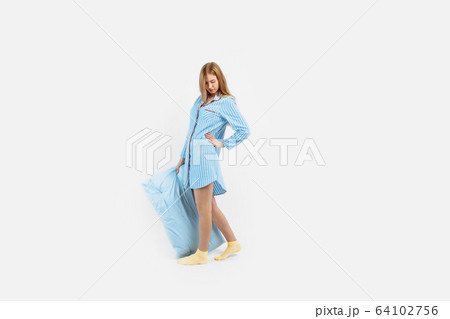 Beautiful young girl in blue pajamas, with a Beautiful young girl in blue pajamas, with a 64102756