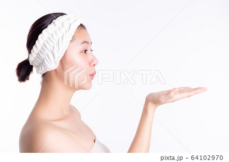 Beautiful young asian woman showing, looking at hand of copy space. Attractive beautiful girl love product, goods. Pretty woman gets satisfied product of skin care, soap, after bath. skincare concept 64102970