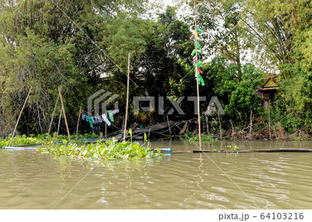 Traditional Thai house by the water Traditional Thai house by the water 64103216
