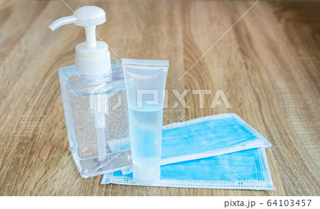 Prevention of infection from the Corona virus. Alcohol gel for washing hands and a sanitary mask on the wooden table,washing hands and wearing a sanitary mask every time to prevent infectio Prevention of infection from the Corona virus. Alcohol gel for washing hands and a sanitary mask on the wooden table,washing hands and wearing a sanitary mask every time to prevent infectio 64103457