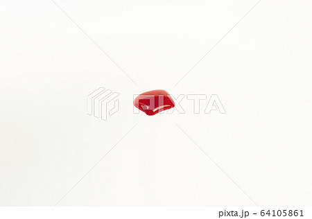 Blood droplet on white paper background 64105861