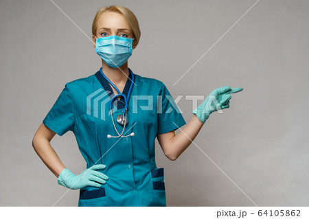 medical doctor nurse woman wearing protective mask and latex gloves - showing at empty copy space 64105862