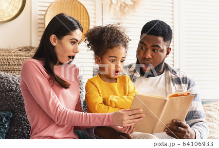 International family at home reading amazing fairytale 64106933