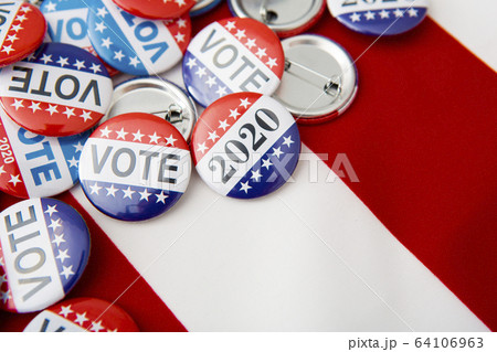 American vote badges on national USA flag background 64106963