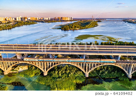 Kiev Urban Train on the Darnytsia Bridge across the Dnieper in Ukraine 64109402