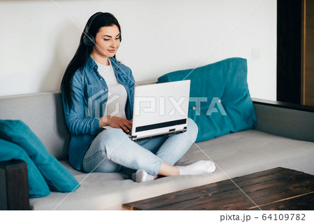 Young woman working from home online using laptop 64109782