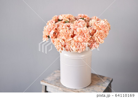 Bouquet of carnation flowers peach color. Spring background. Clove bunch present for Mothers Day. Bouquet of carnation flowers peach color. Spring background. Clove bunch present for Mothers Day. 64110169