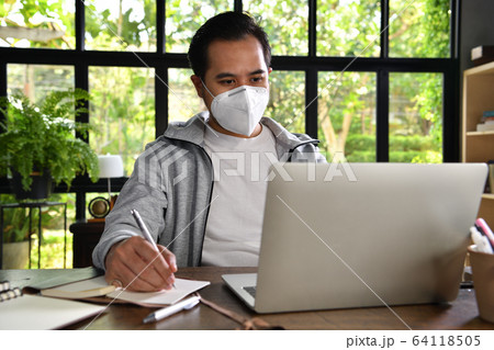 Asian man wearing surgical mask work from home,Coronavirus Asian man wearing surgical mask work from home,Coronavirus 64118505